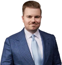 Portrait of a man in a blue checkered suit and light blue tie on a white background