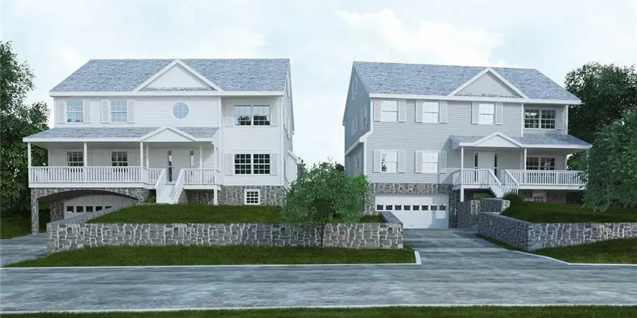 A couple of houses are sitting next to each other on a hill.