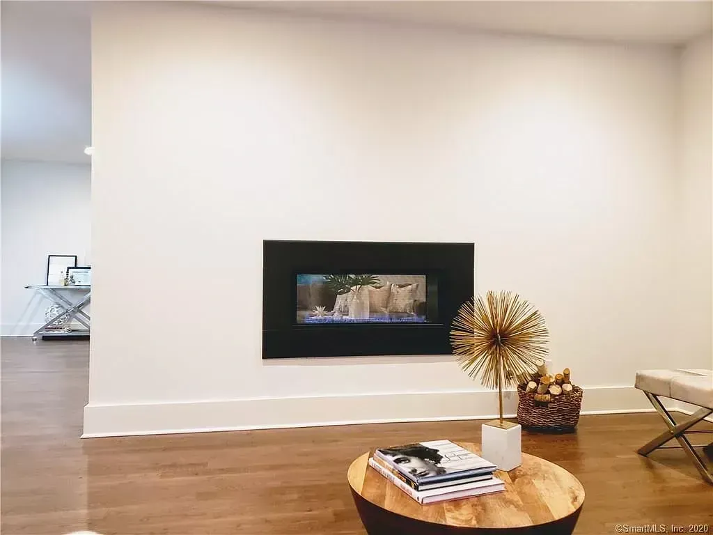 A living room with a fireplace and a wooden table.