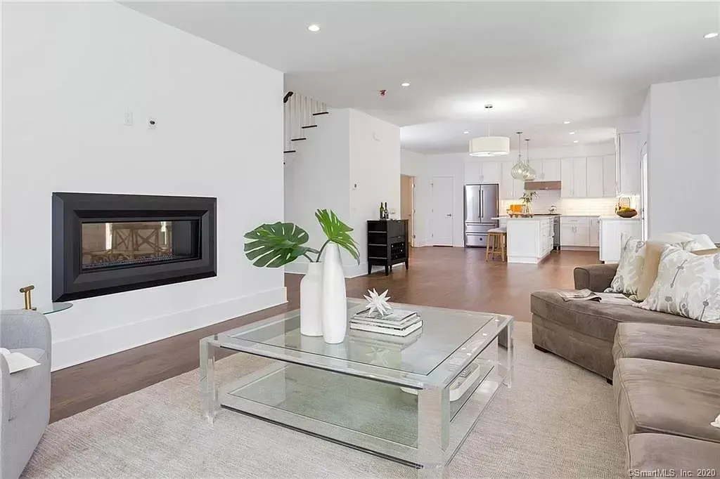 A living room with a fireplace and a coffee table