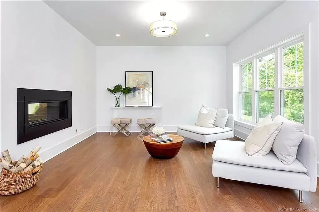 A living room with hardwood floors and a fireplace
