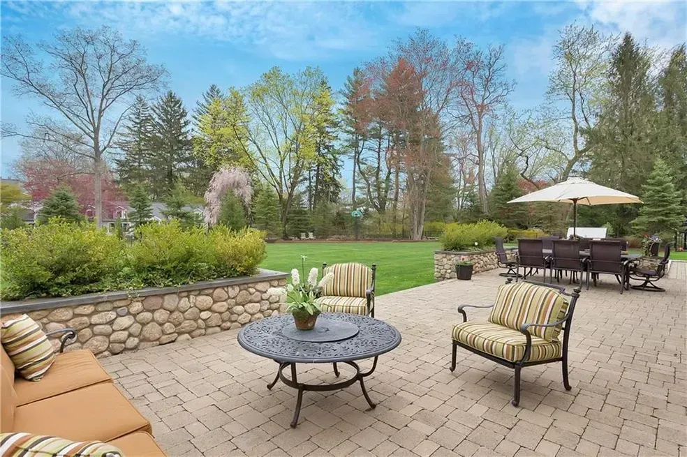 A patio with a table and chairs and an umbrella