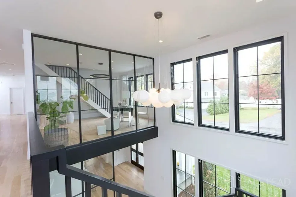 A large room with a lot of windows and a staircase.