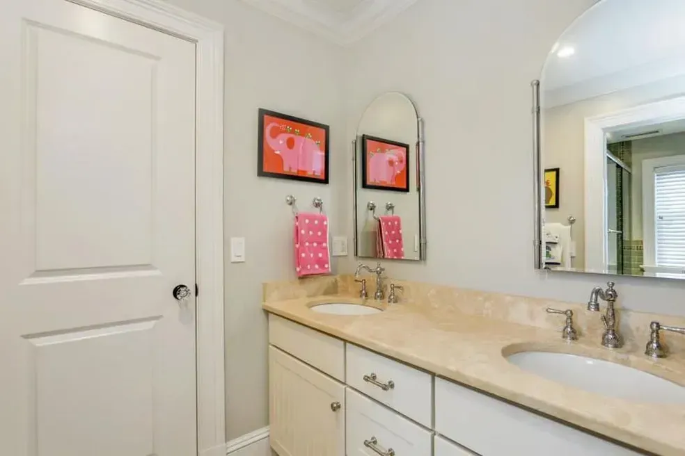 A bathroom with two sinks and a mirror.