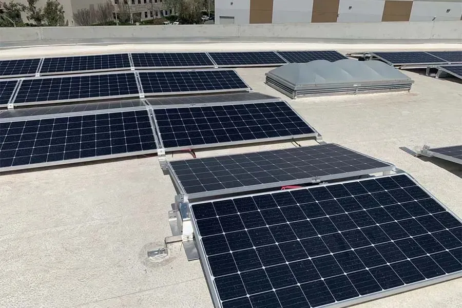 Solar panels mounted on a flat rooftop under bright daylight