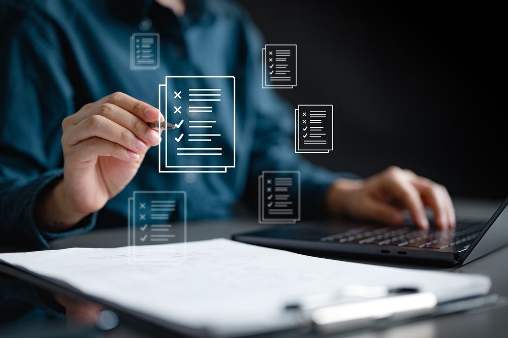 Person using a laptop with a digital checklist interface hovering above the keyboard