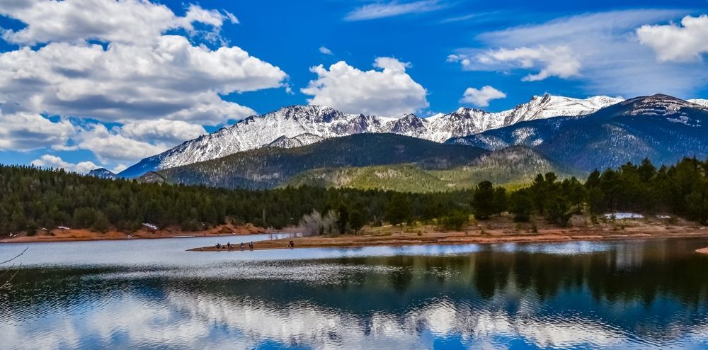 Pikes Peak panorama. Snow-capped and forested mountains near a mountain lake, Pikes Peak Mountains in Colorado Spring, Colorado, USA