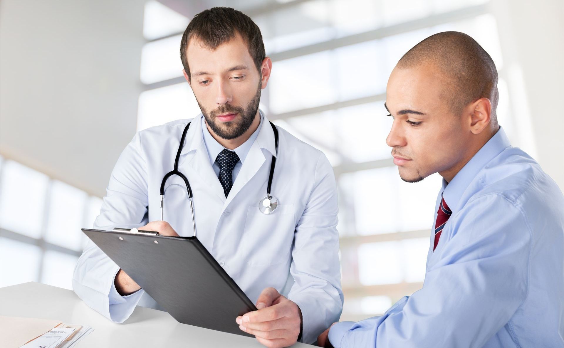 A Doctor and an interviewing candidate speak with one another, the doctor would like to ask the question How can CRAs detect counterfeit healthcare diplomas?