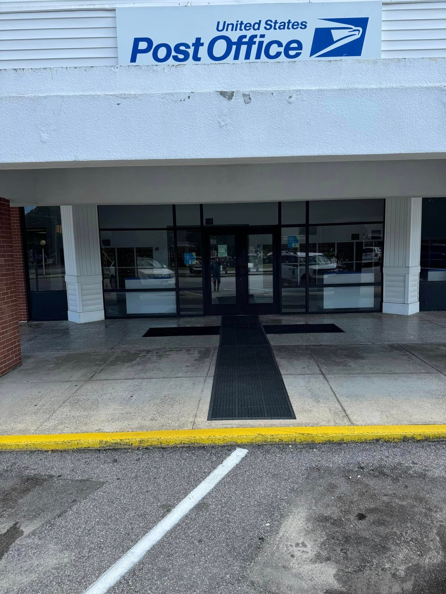 Austintown Post Office entrance with glass doors and blue sign above the awning.