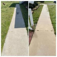 Before-and-after view of a concrete sidewalk, with a dark repaired section on the left and a clean sidewalk on the right