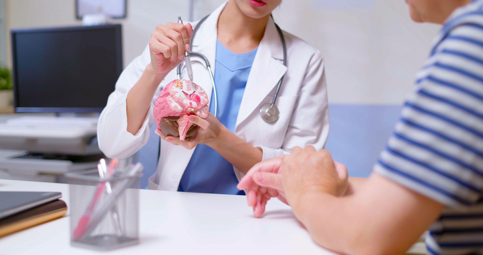 A Doctor Explaining A Brain Sample — The Law Offices Of Cardaro & Peek, LLC