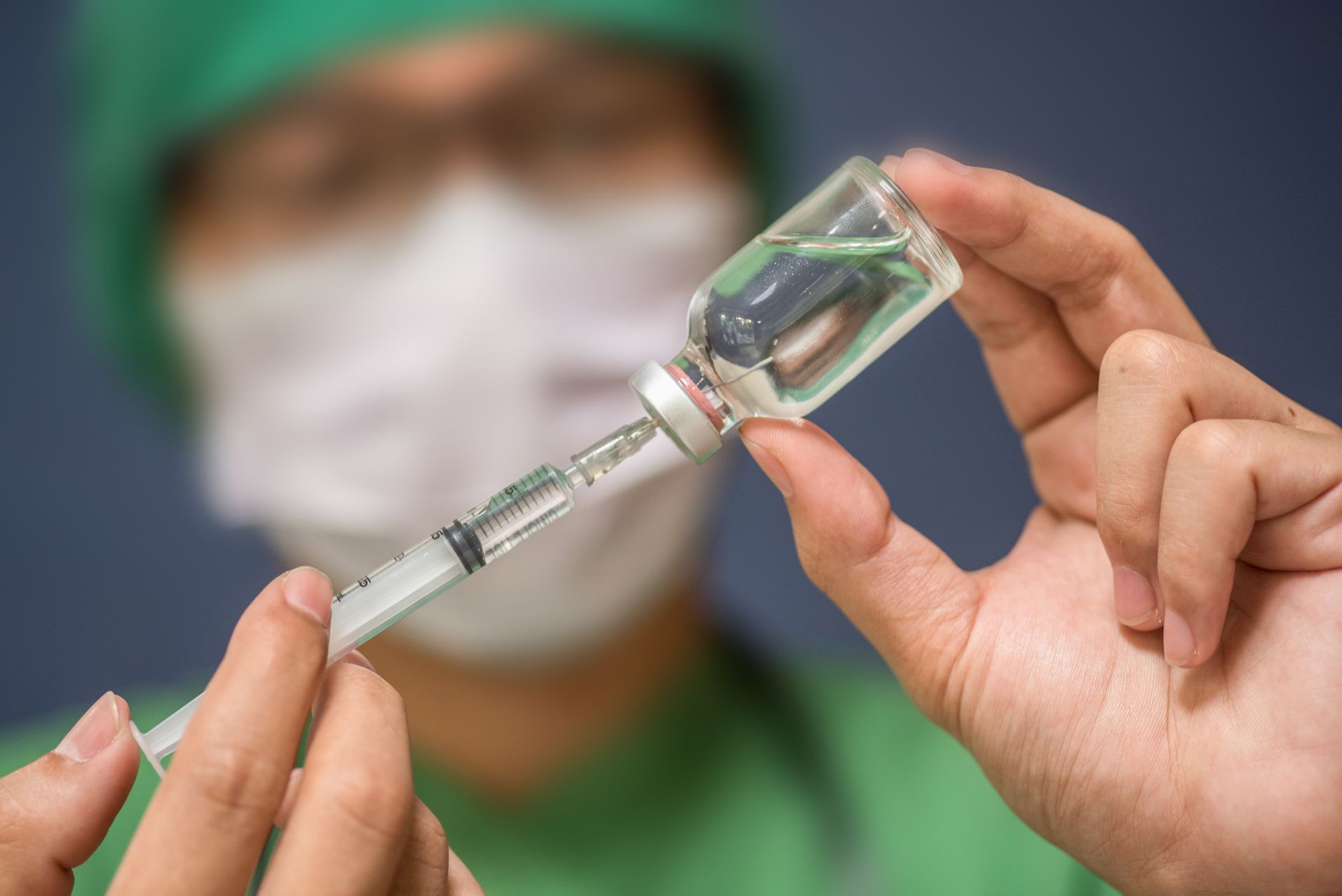 Doctor Holding Syringe And Medicine — Baltimore & Washington DC — The Law Offices Of Cardaro & Peek, LLC Doctor Holding Syringe And Medicine — Baltimore & Washington DC — The Law Offices Of Cardaro & Peek, LLC