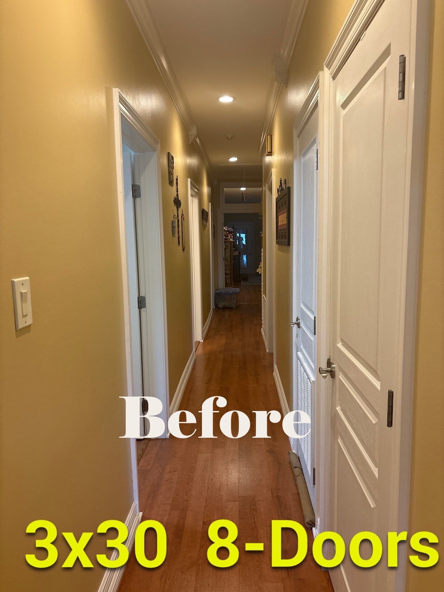 Narrow hallway with eight doors, tan walls, hardwood floor, and white door frames.