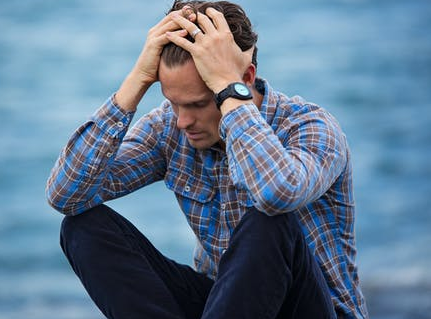 A man having anxiety sitting by the sea