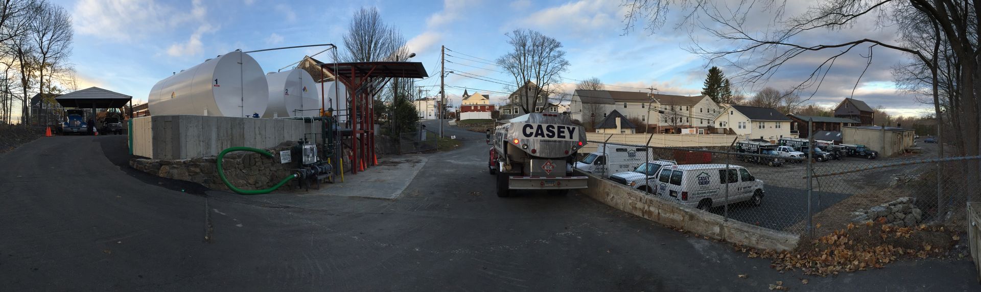 A truck is parked on the side of the road in a parking lot.