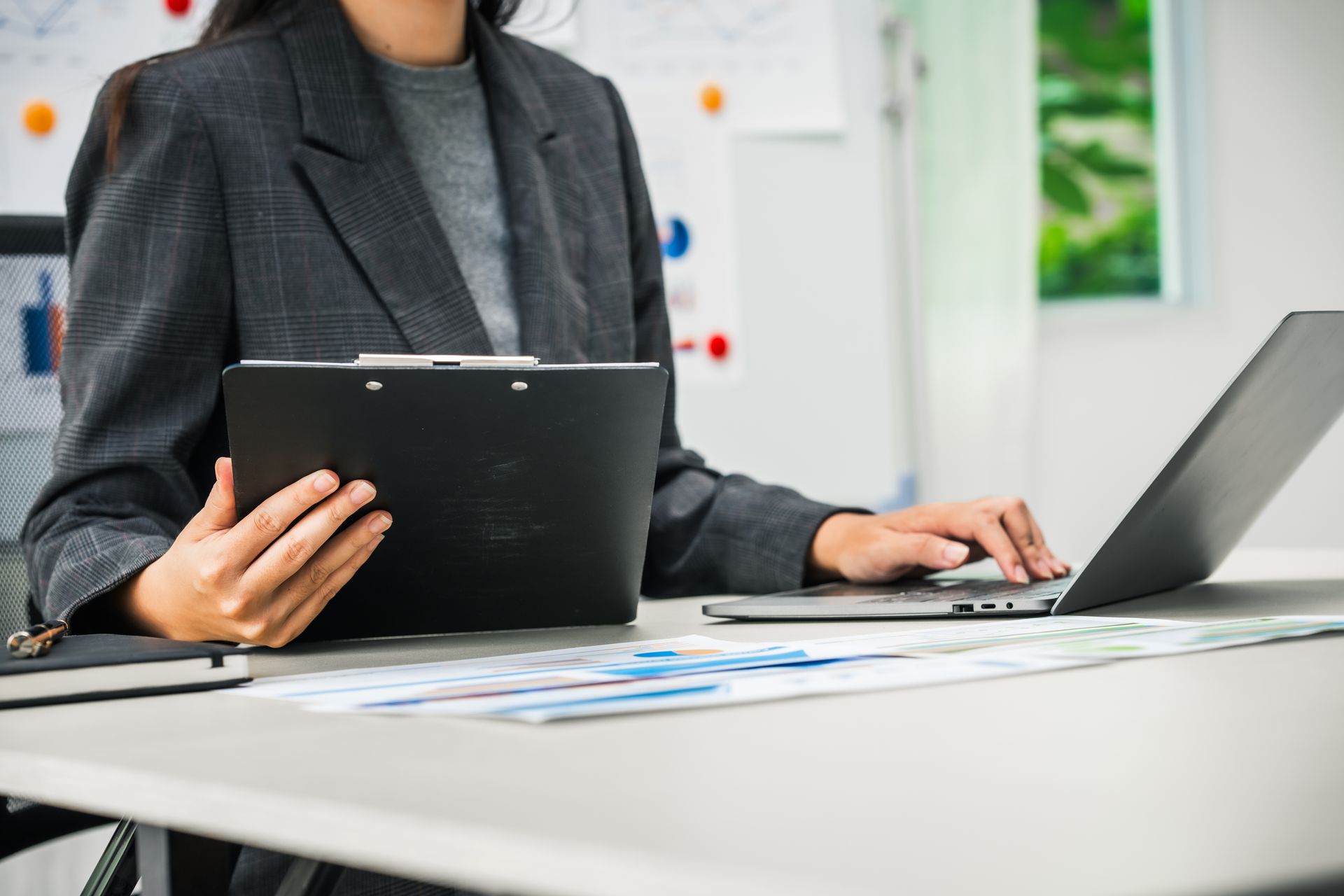 A businesswoman works diligently at her desk.