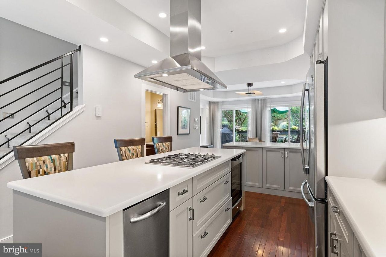 A kitchen with stainless steel appliances and a large island.