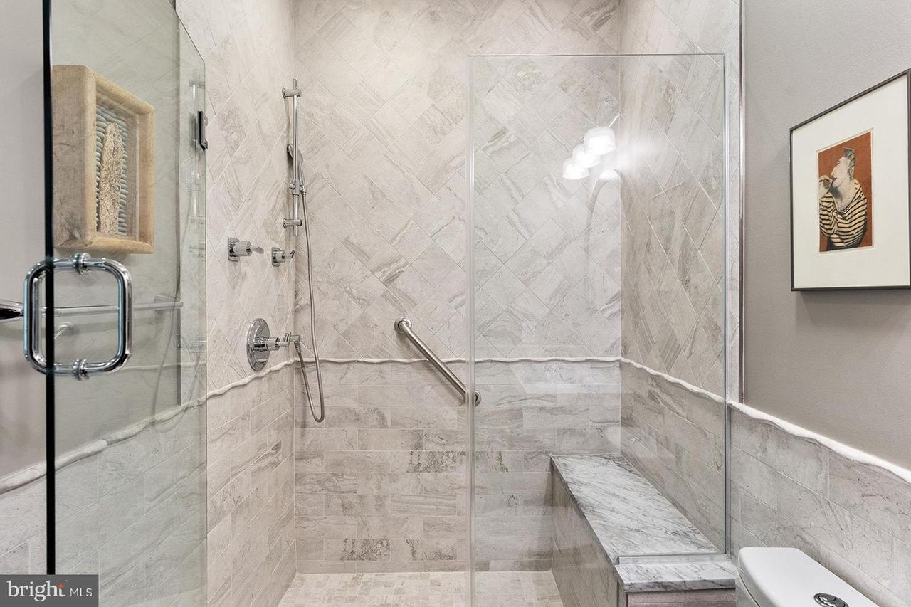 A bathroom with a walk in shower and a toilet.