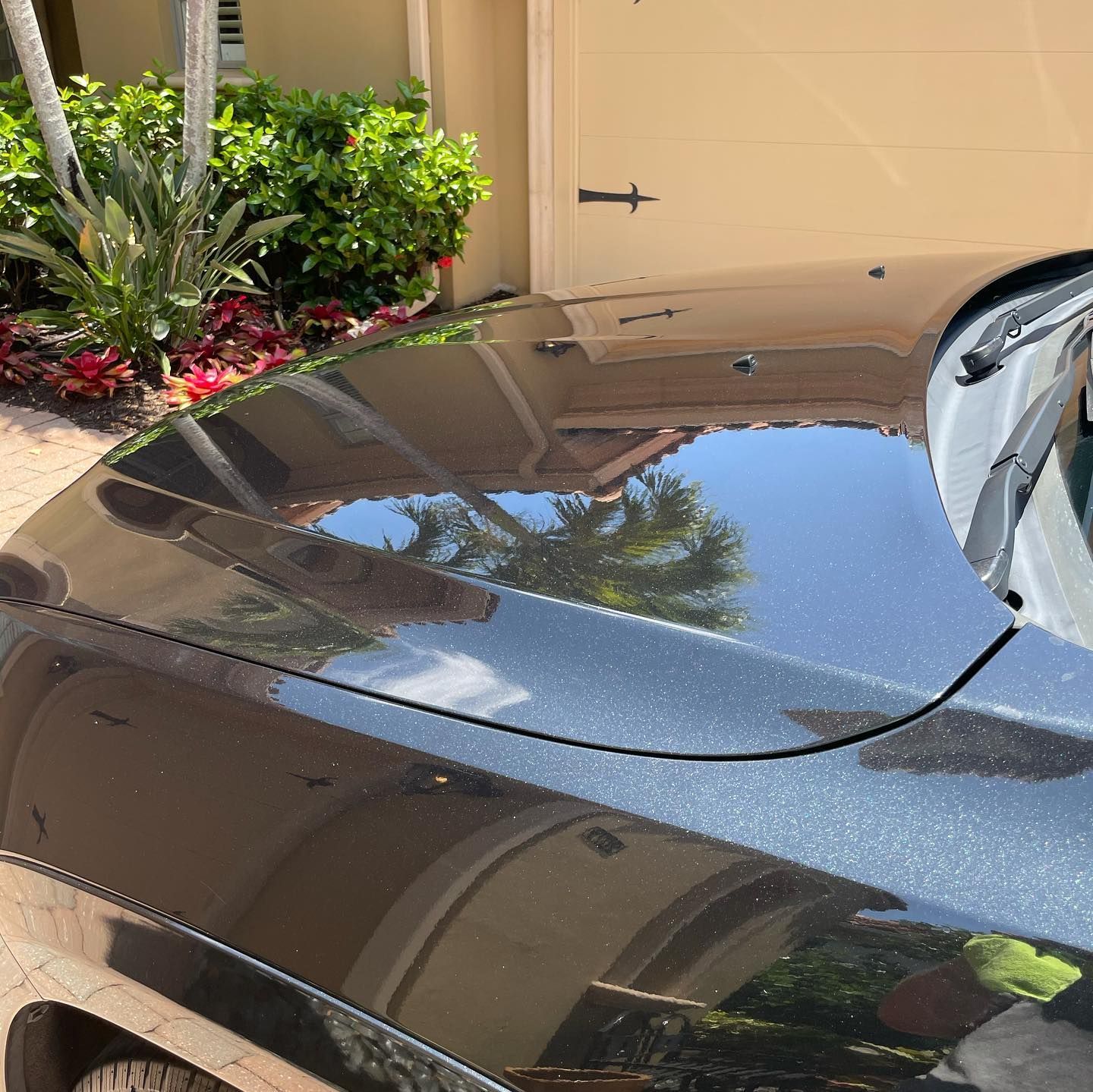 a black car is parked in front of a garage door