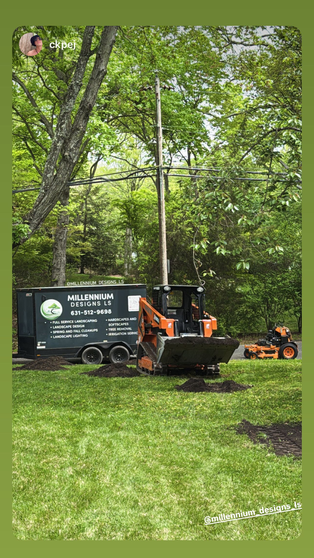 Tree service truck and loader on a grassy yard beside tall trees and a utility pole