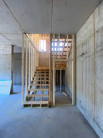 An empty room with a staircase in the middle of it