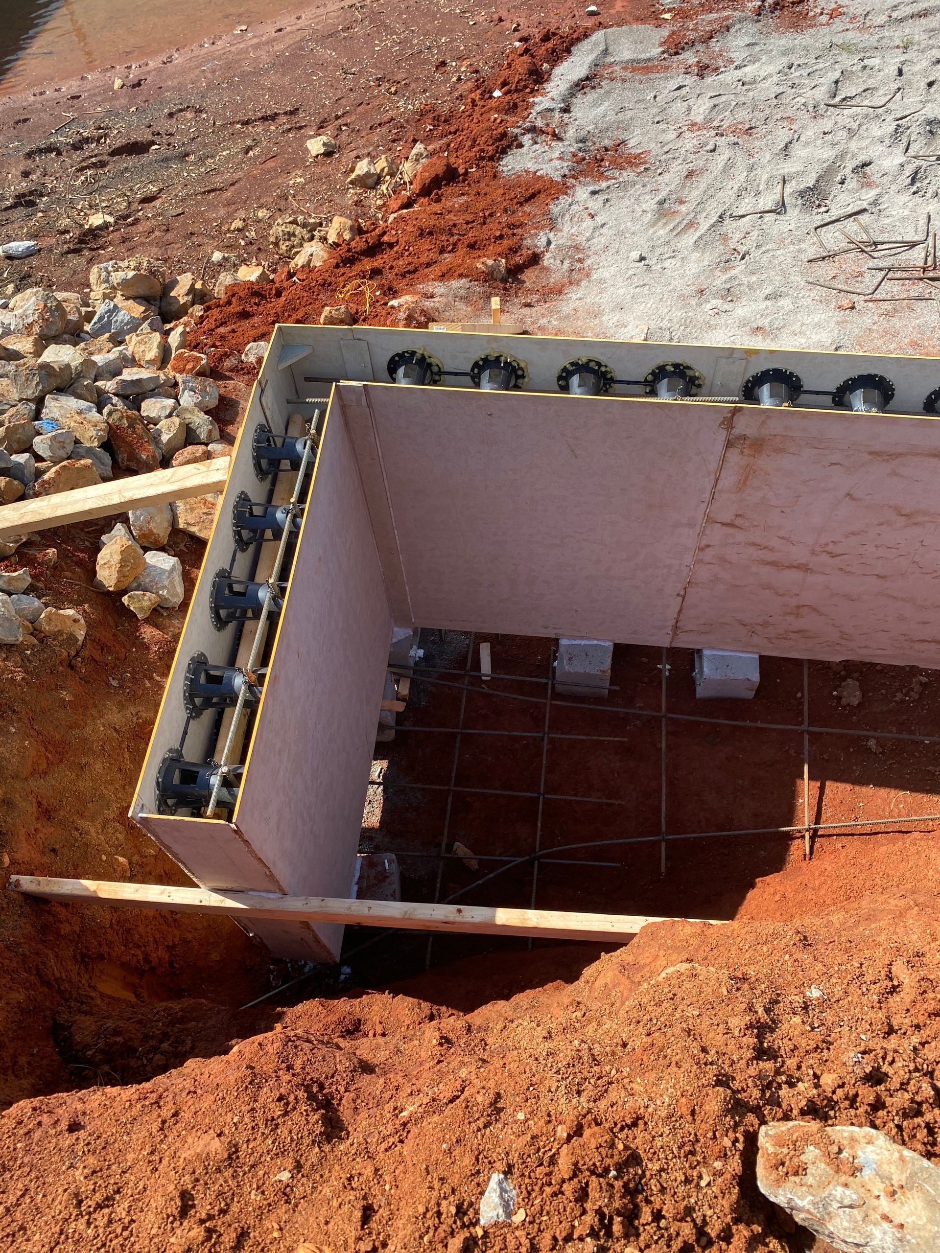 A box is sitting in the middle of a pile of dirt.