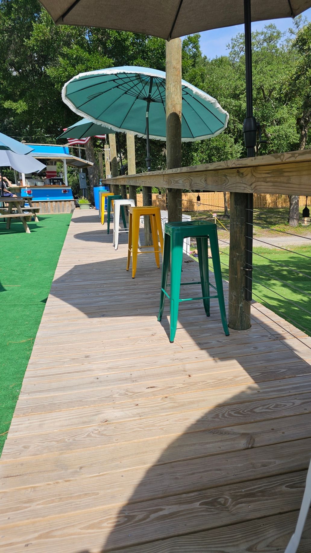 Umbrella and benches outside at Rhody Bros. of Florida