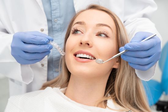 A woman is getting her teeth examined by a dentist, showcasing dentist services. A woman is getting her teeth examined by a dentist, showcasing dentist services.