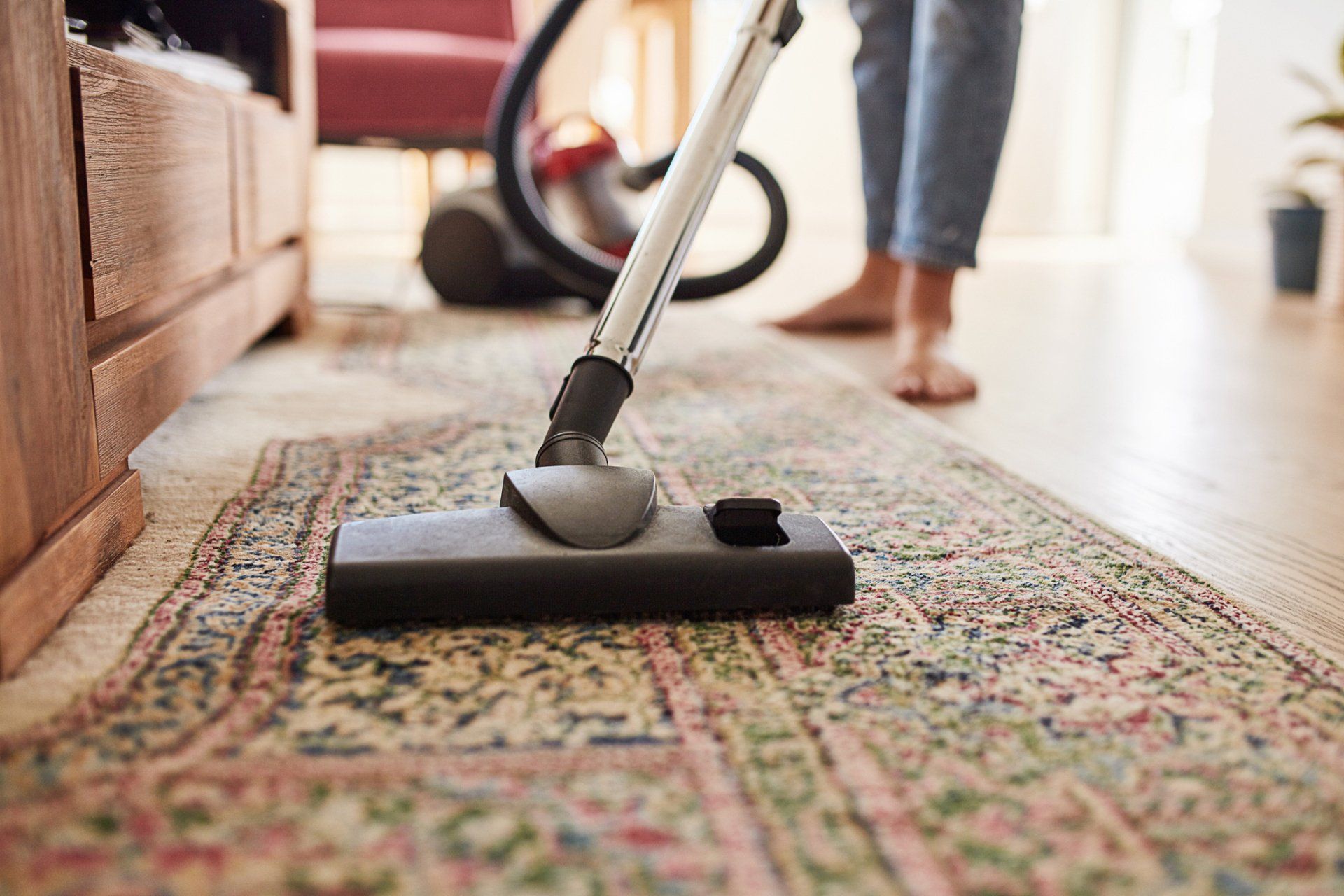 Woman Vacuuming the Living Room — Bakersfield, CA — Handmaids House Cleaning