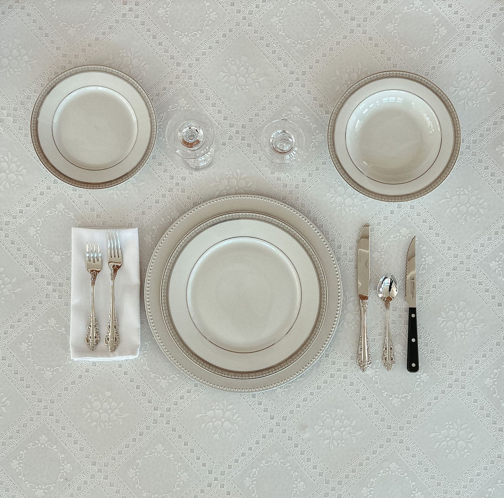 A table setting with plates and silverware on it