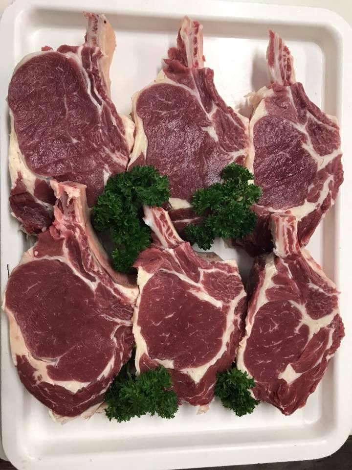 A White Tray Filled with Steaks and Parsley on A Table — Holiday Coast Meat & Smallgoods in Clarence Valley, NSW