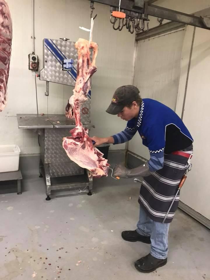 A Man Is Cutting a Piece of Meat in A Butcher Shop — Holiday Coast Meat & Smallgoods in South Grafton, NSW