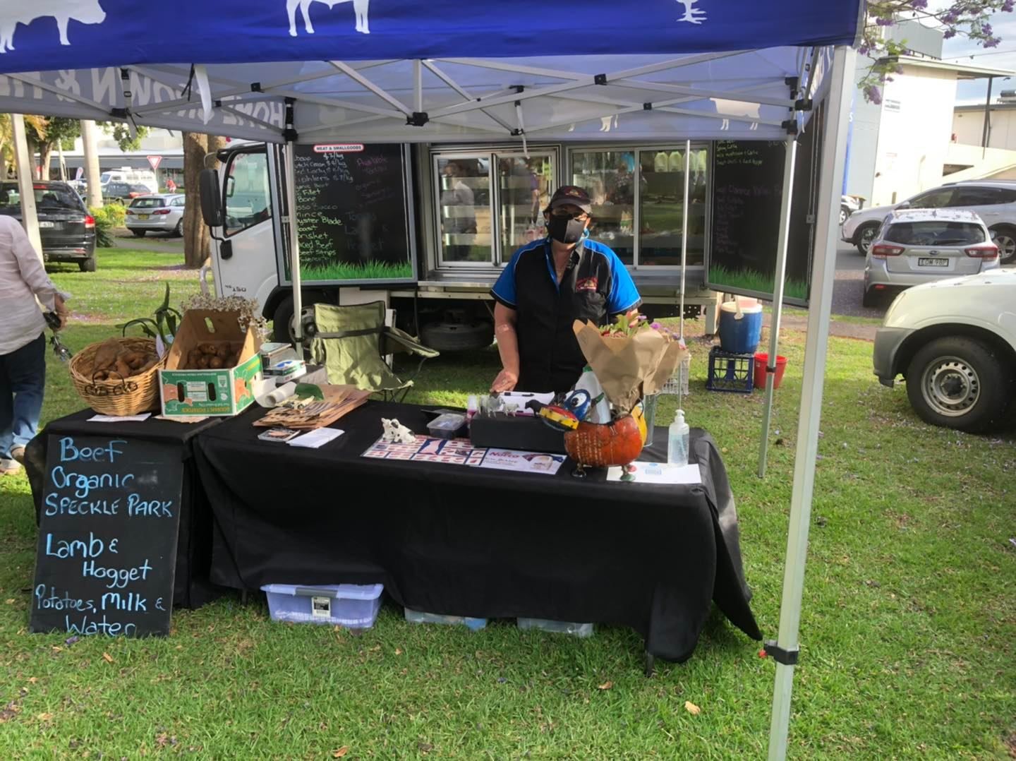A man is standing behind a table under a tent — Holiday Coast Meat & Smallgoods in South Grafton, NSW