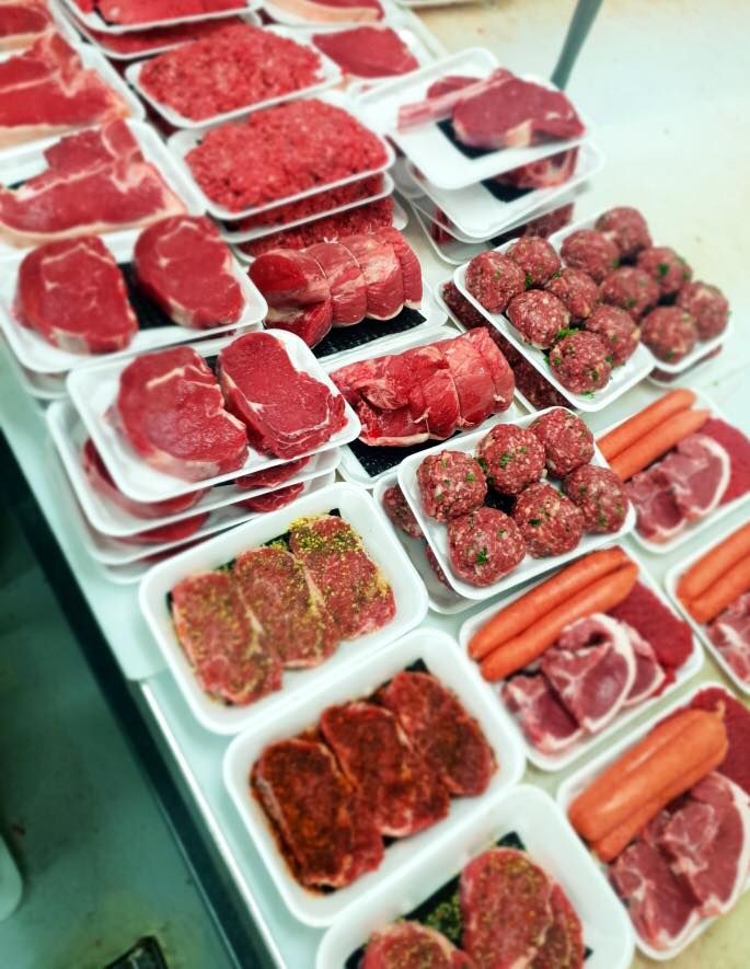 Many trays of meat and vegetables on a table — Holiday Coast Meat & Smallgoods in South Grafton, NSW