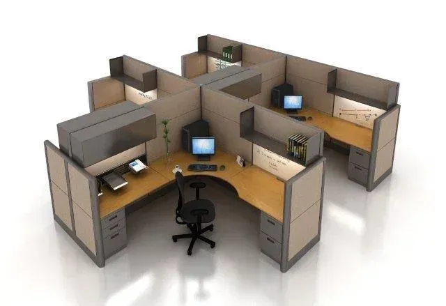 Office cubicles with computers and an office chair. Beige walls, gray accents, and wooden desks.