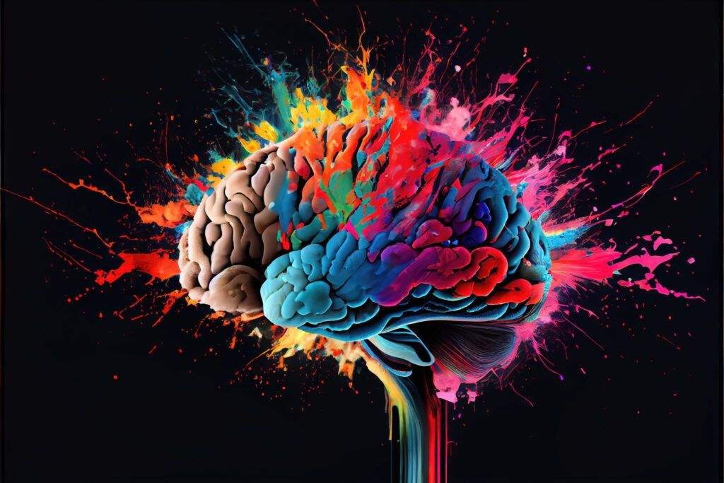 Colorful brain splashed with neon paint on a dark background