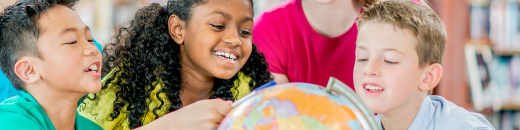 Children smiling and playing with colorful toys in a bright classroom