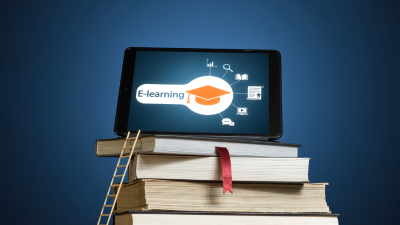 Tablet displaying e-learning on a stack of books against a blue background