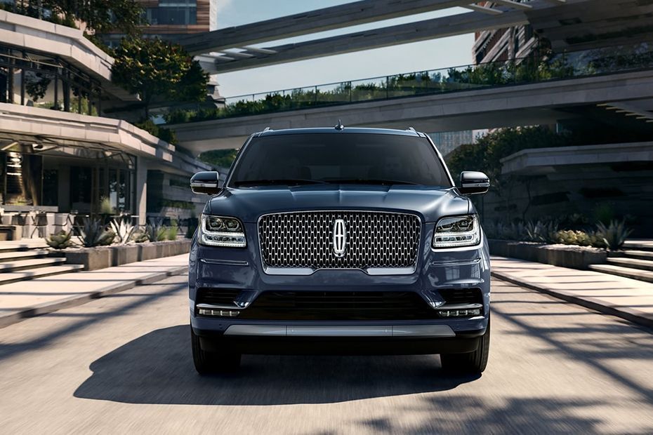 Front view of a black luxury SUV parked in a modern outdoor plaza