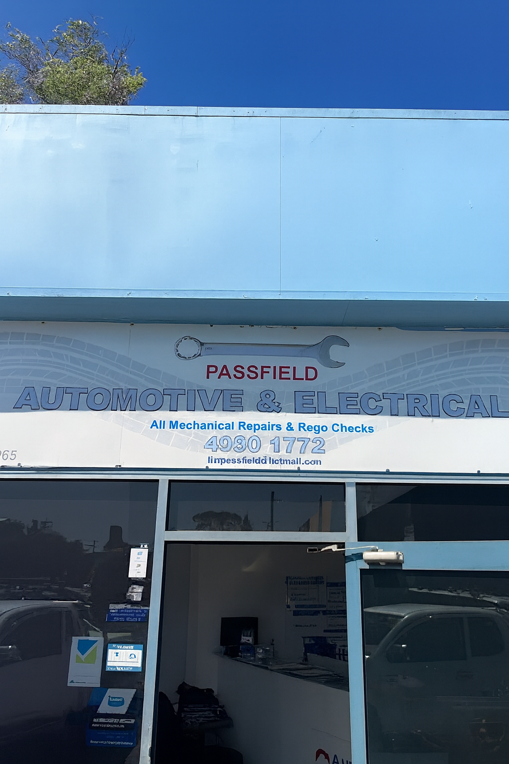 A Man Is Working On A Car With The Hood Open — Passfield Automotive and Electrical In Cessnock, NSW