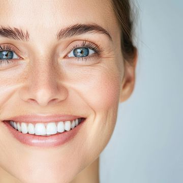 Close-up of a smiling woman with blue eyes