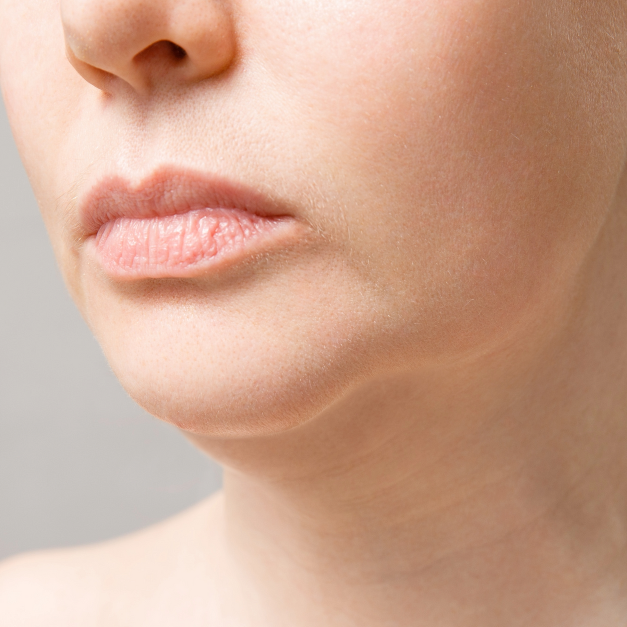 Close-up of a woman's chin.