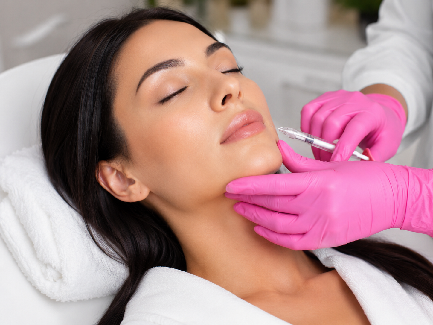 A woman receiving a skin booster treatment called Sunekos Performa in a clinic
