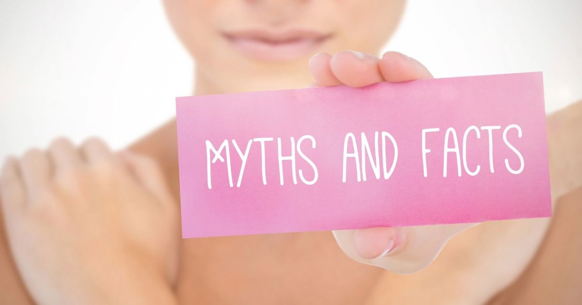 Person holding pink card reading “MYTHS AND FACTS”