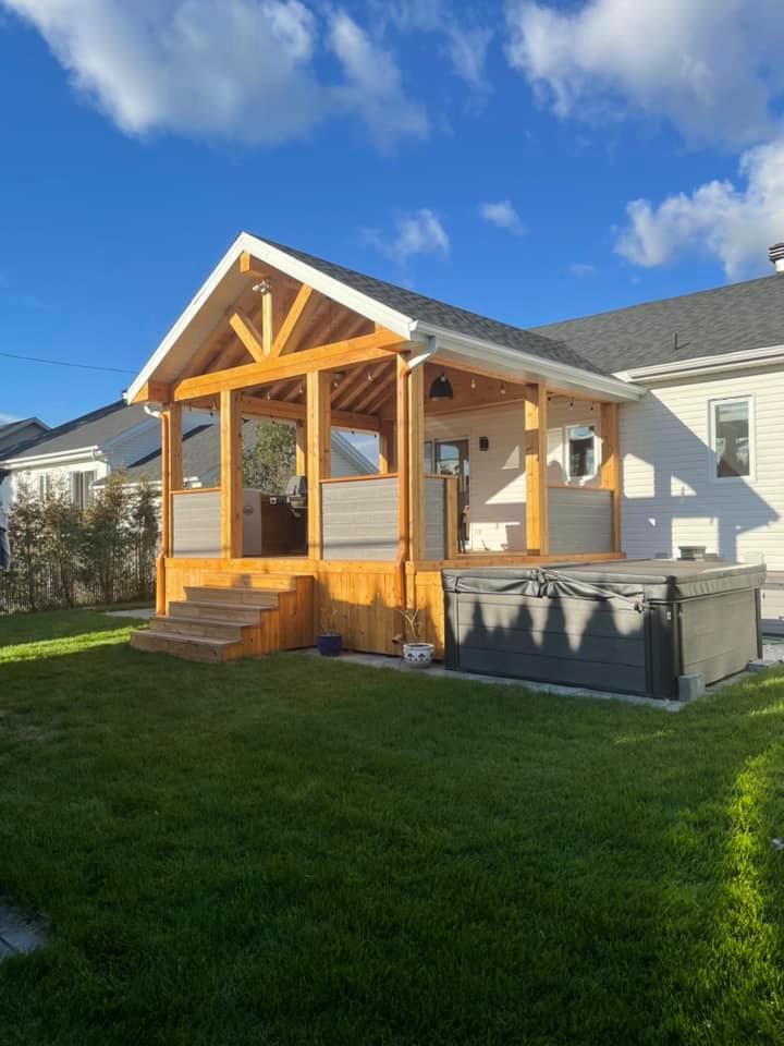 une maison avec un porche et un bain à remous dans la cour.