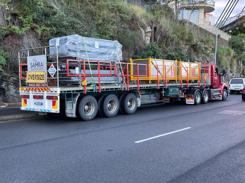 A large semi truck is driving down a road.