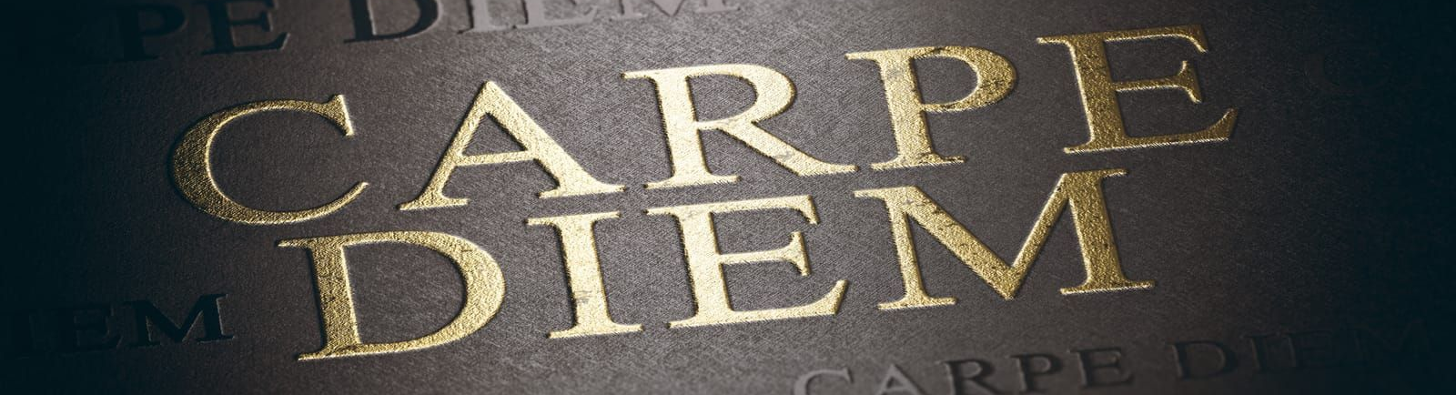 Carpe Diem stamped in gold on a dark background