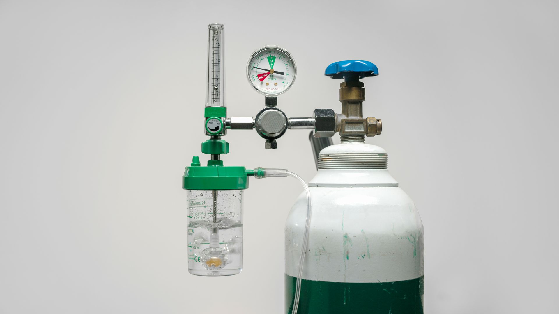 Medical oxygen cylinder with regulator, pressure gauge, and flow meter attached