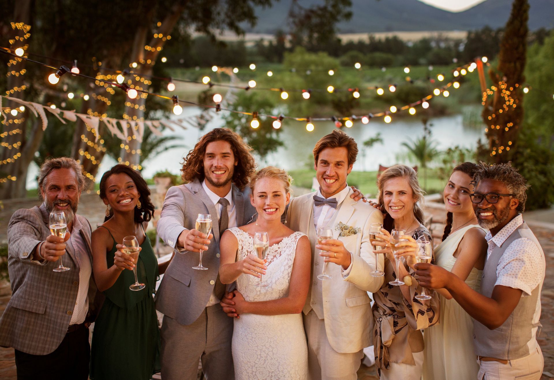 A bride and groom are toasting with their wedding party at their wedding reception. A bride and groom are toasting with their wedding party at their wedding reception.