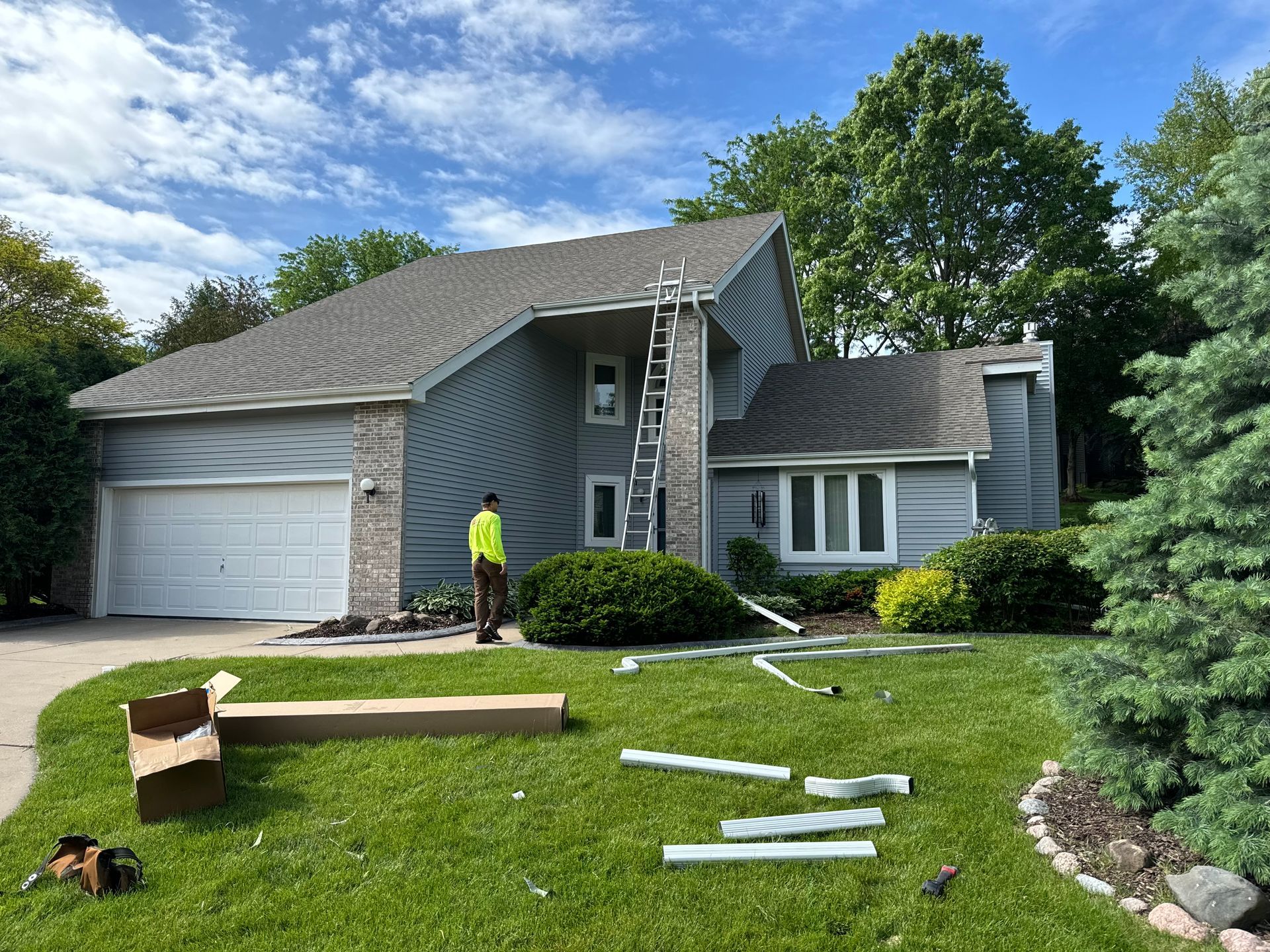 Finished custom-bent fascia and exterior trim on the side of a gray home in Janesville, Wisconsin.